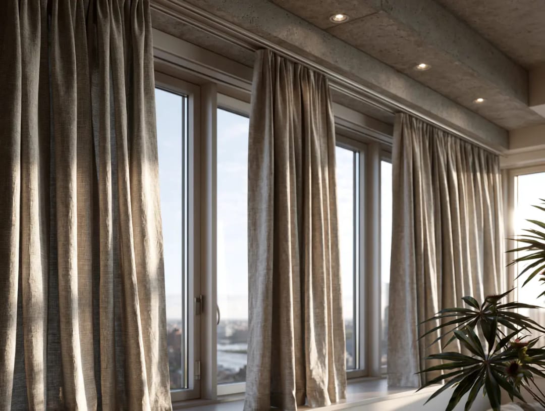 Linen curtains on a track fixed into a concrete ceiling above a row of tall windows
